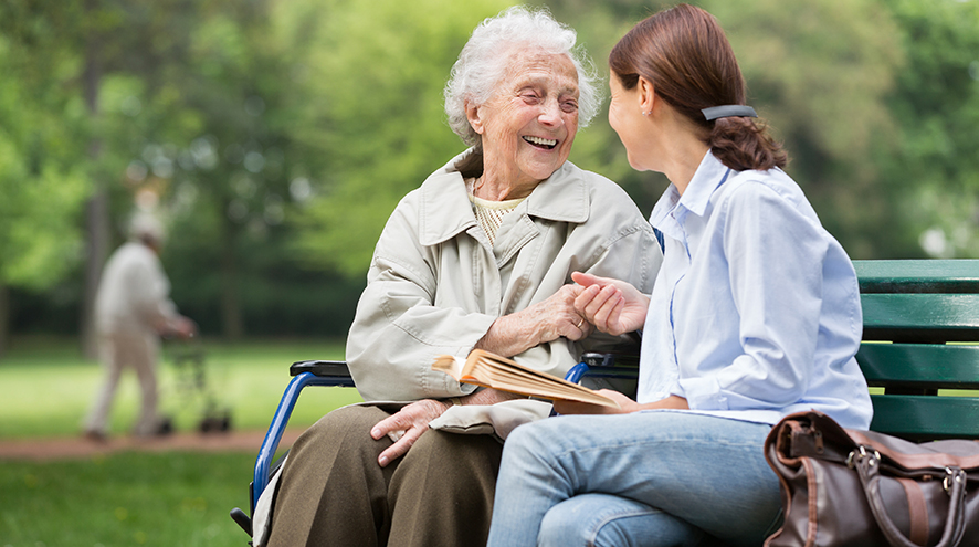 Mother and daughter talking in the park.