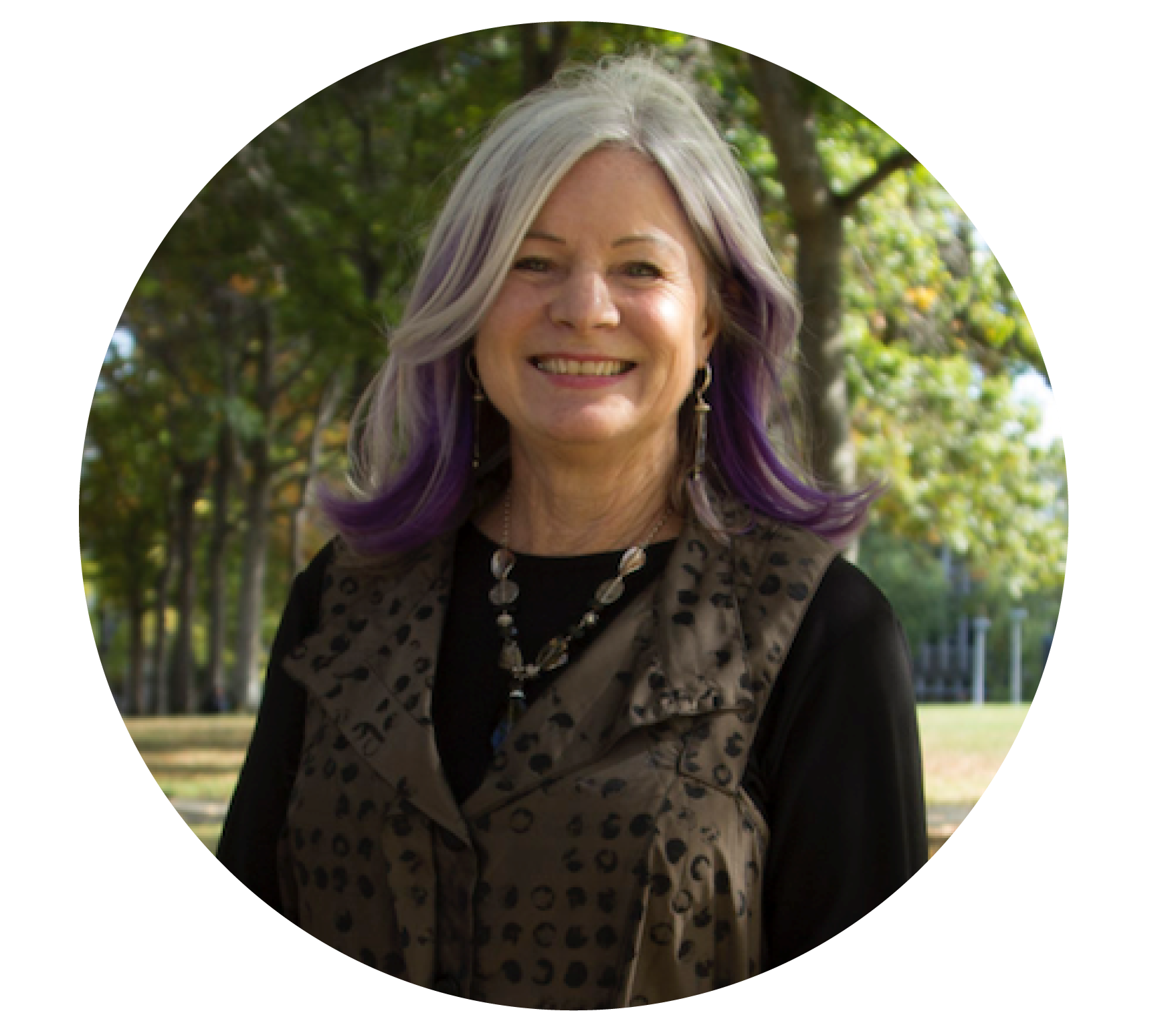 Woman with grey and purple hair smiling